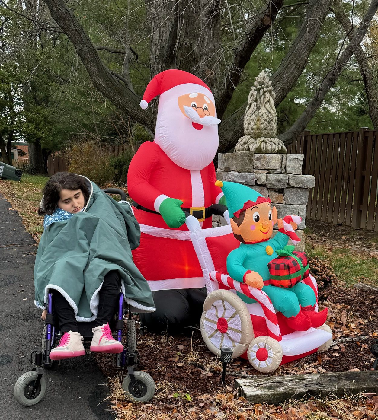 holiday inflatable of a Santa and Elf in a wheel chair